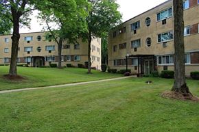 St. Louis apartment for rent - a grassy area with trees in front of a building