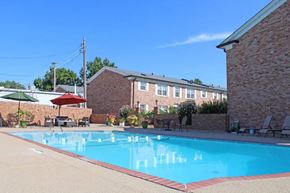 Webster Groves apartment for rent - a swimming pool with a brick building in the background