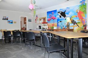 Webster Groves apartment for rent - a room with a long table with black chairs and colorful paintings on the wall