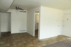 Olivette apartment for rent - a living room with a ceiling fan and white walls