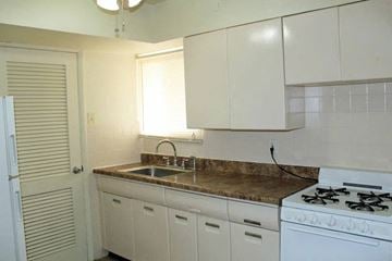 Olivette apartment for rent - a kitchen with a stove and a sink