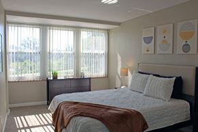 St. Louis apartment for rent - a bedroom with a bed and three windows