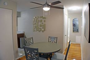 St. Louis apartment for rent - a dining room with a table and a ceiling fan