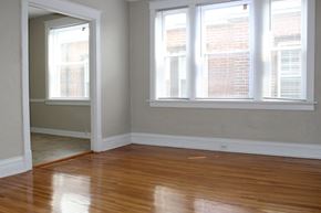 St. Louis apartment for rent - A room with wooden floors and two windows.