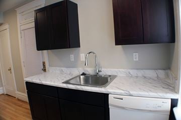 St. Louis apartment for rent - A kitchen with a white counter top and a washing machine.