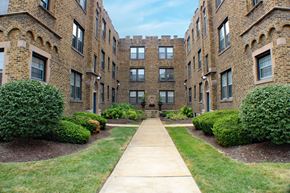 St. Louis apartment for rent - A long concrete walkway leads between two rows of buildings.