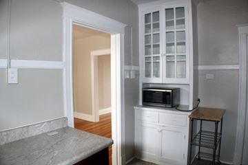 St. Louis apartment for rent - A kitchen with a microwave on top of a cabinet.