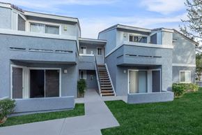 Barstow apartment for rent - A modern two-story house with a grey exterior and a white front door.