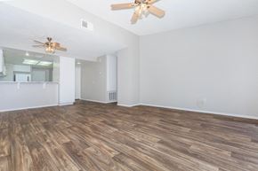 Hesperia apartment for rent - the living room and dining room with wood flooring and a ceiling fan