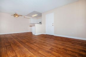 Hesperia apartment for rent - an empty living room with wood floors and a ceiling fan