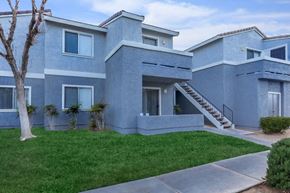 Barstow apartment for rent - A modern house with a grey exterior and a tree in front.