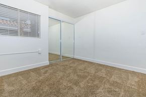 Las Vegas apartment for rent - a bedroom with a mirrored closet and a carpeted floor