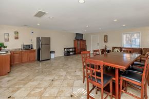 Indio apartment for rent - a kitchen and dining room with a wooden table and chairs