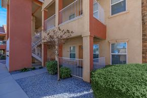 Hesperia apartment for rent - an exterior view of an apartment building with balconies and a sidewalk