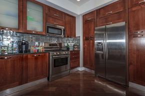 Las Vegas apartment for rent - a kitchen with stainless steel appliances and wooden cabinets