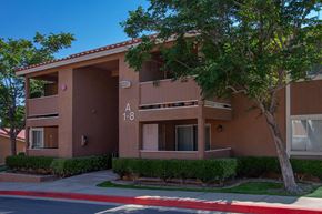 Hesperia apartment for rent - a building with a sidewalk and a tree in front of it