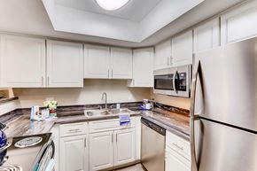 Las Vegas apartment for rent - a kitchen with stainless steel appliances and white cabinets