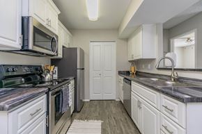 Las Vegas apartment for rent - a kitchen with stainless steel appliances and white cabinets