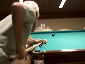 Lompoc apartment for rent - an older man playing a game of pool