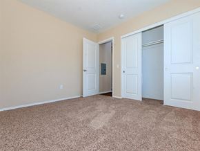Lompoc apartment for rent - an empty bedroom with three doors and carpeting