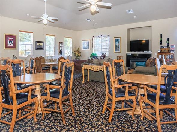 Lompoc apartment for rent - a living room with wooden tables and chairs and a television
