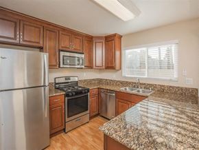 Orange apartment for rent - a kitchen with granite counter tops and stainless steel appliances