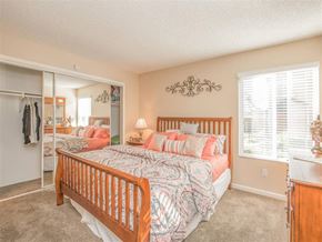 Orange apartment for rent - a bedroom with a bed and a closet