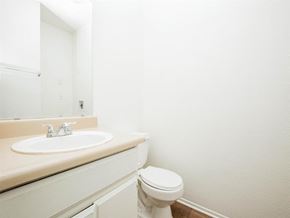 Palm Springs apartment for rent - A white toilet sits next to a sink in a bathroom.