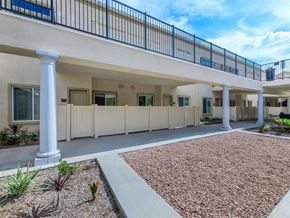 Riverside apartment for rent - A row of white columns support a balcony in front of a building.