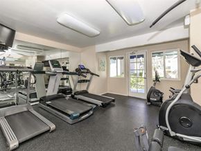 Santa Ana apartment for rent - A spacious gym with treadmills, elliptical machines, and other exercise equipment.