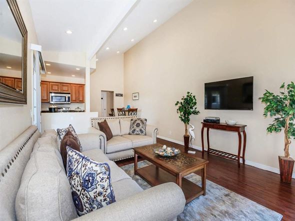 Ventura apartment for rent - A living room with a grey couch and a wooden coffee table.