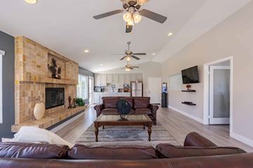 Rosamond apartment for rent - A living room with a brown leather couch and a fireplace.