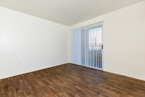 Las Vegas apartment for rent - an empty living room with wood flooring and a window