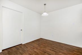 Las Vegas apartment for rent - a bedroom with white walls and wood flooring and a closet