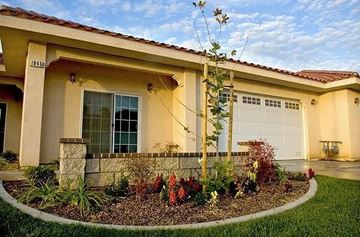 Redlands apartment for rent - A house with a well-maintained garden in front.