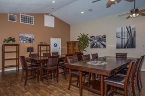 Victorville apartment for rent - A dining room with a wooden table and chairs.