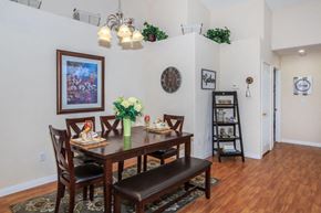 Victorville apartment for rent - A dining room with a wooden table and chairs.