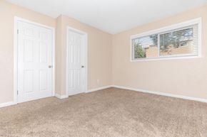 San Diego apartment for rent - an empty bedroom with two doors and a window