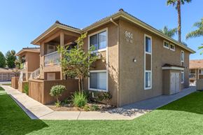 Vista apartment for rent - A beige two-story apartment building with the number 951 on the front.