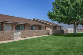 Hesperia apartment for rent - A house with a green lawn and a tree in front.
