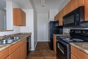 Phoenix apartment for rent - a kitchen with black appliances and granite counter tops