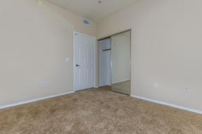 Phoenix apartment for rent - a bedroom with a door to a closet and a carpeted floor