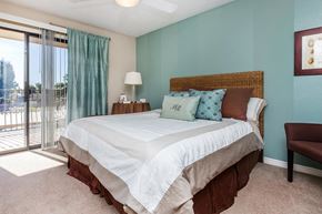Mesa apartment for rent - a bedroom with a bed and a sliding glass door