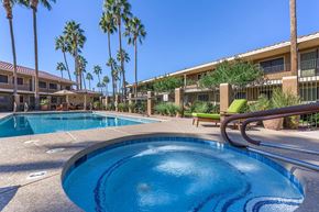 Mesa apartment for rent - a large swimming pool with a hot tub in front of a resort building