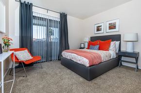 Phoenix apartment for rent - a bedroom with a bed and a desk with a chair
