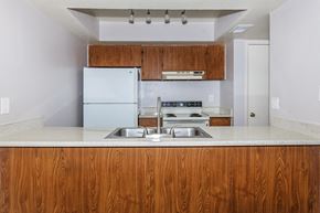 Phoenix apartment for rent - a kitchen with white appliances and wooden cabinets