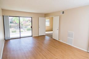 Palm Desert apartment for rent - an empty living room with wood flooring and sliding glass doors