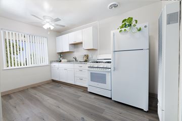 San Jose apartment for rent - A white refrigerator stands in a kitchen with a fan on the ceiling.
