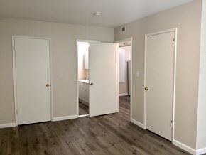 San Jose apartment for rent - Bedroom with white doors and a wood floor