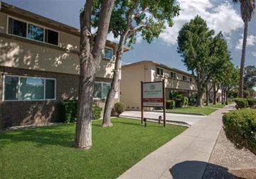 San Jose apartment for rent - A sunny day at a residential area with apartment buildings and greenery.